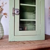 Small glass cabinet in green colour.