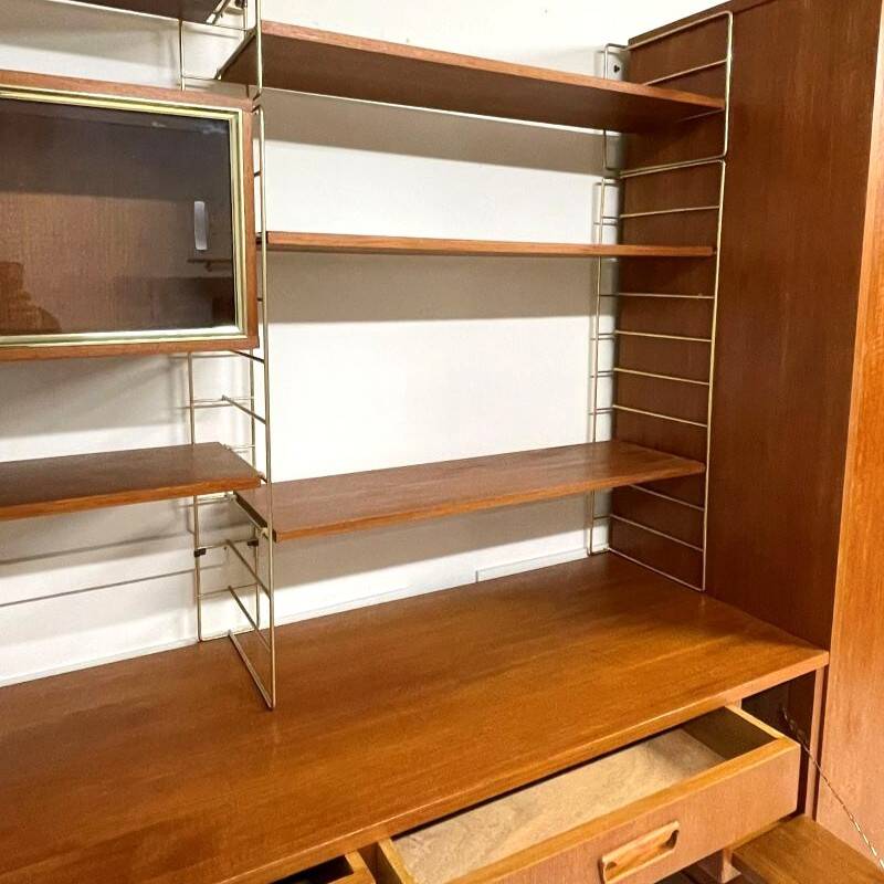 A piece of furniture combining a desk, wardrobe, and shelves.