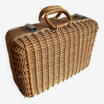 Old wicker suitcase with metal fasteners