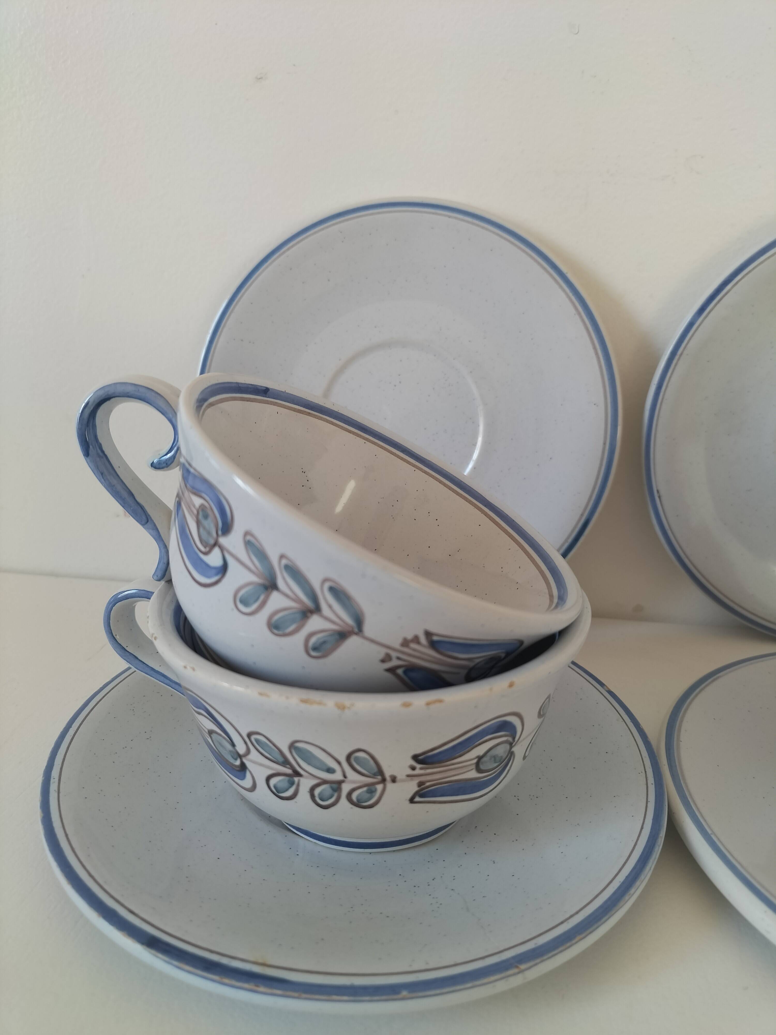 Glazed earthenware cups and saucers