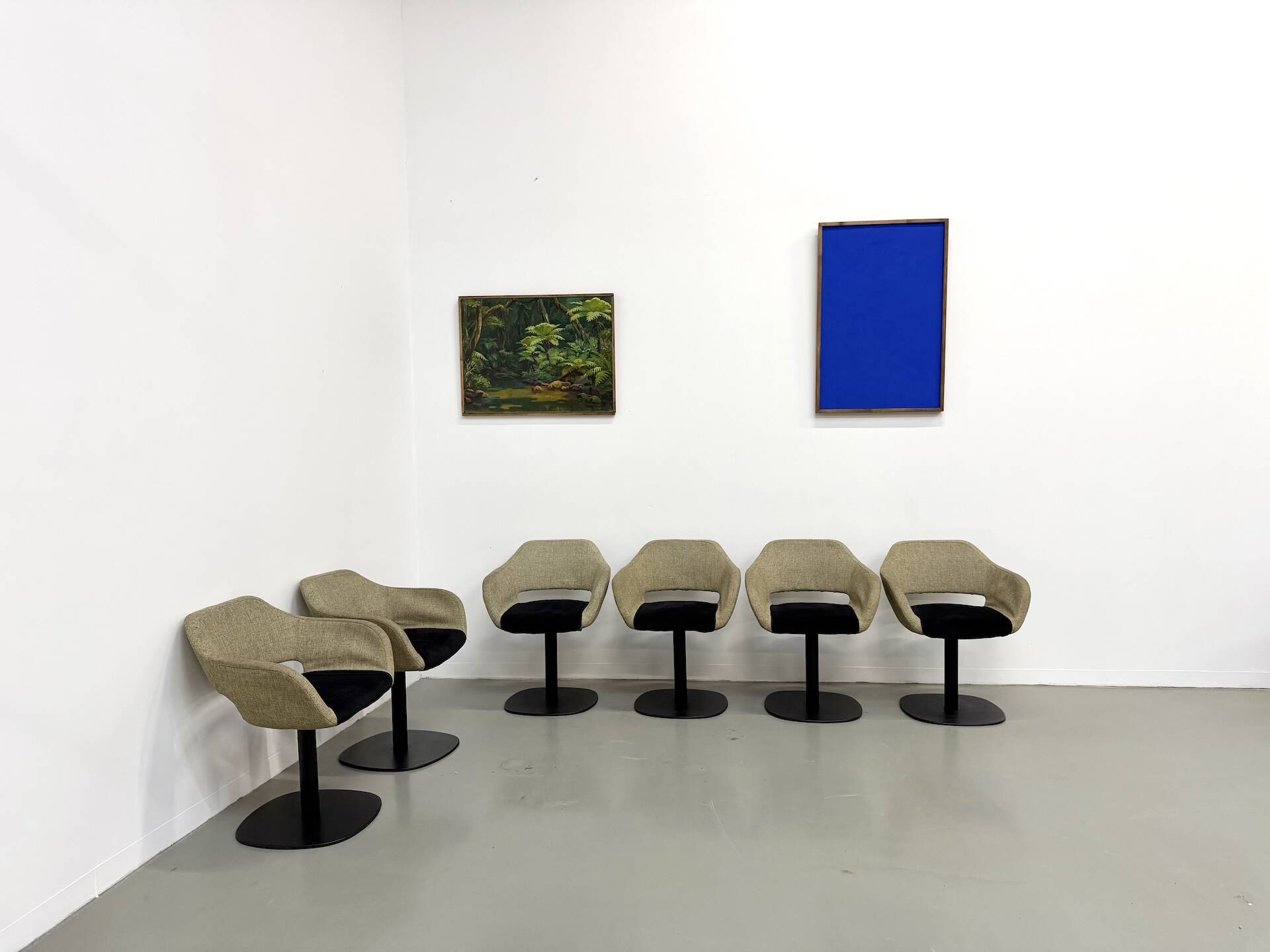 Series of six swivel chairs with an organic shell, patterned fabric and base.