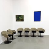 Series of six swivel chairs with an organic shell, patterned fabric and base.