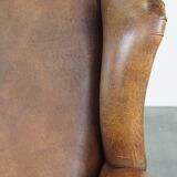 Large sheep leather wingback chair correctly finished with decorative nails