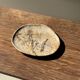 Small beige oval petrified wood dish or tray with crystals.