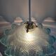 Suspension lampshade with scalloped edges in blue and its interior decoration.