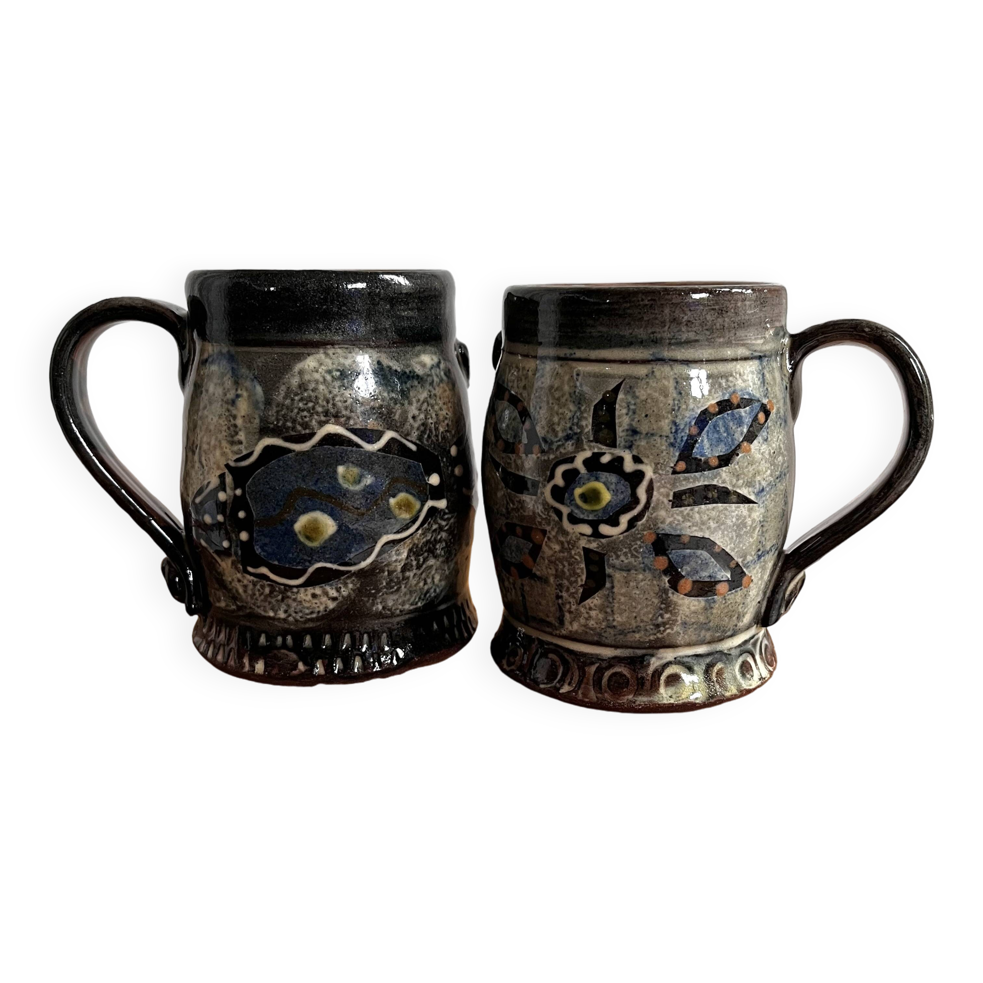 Vintage terracotta mugs with glazed designs and flower/fish motifs