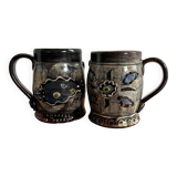 Vintage terracotta mugs with glazed designs and flower/fish motifs