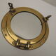 Mirror integrated into a brass navy porthole