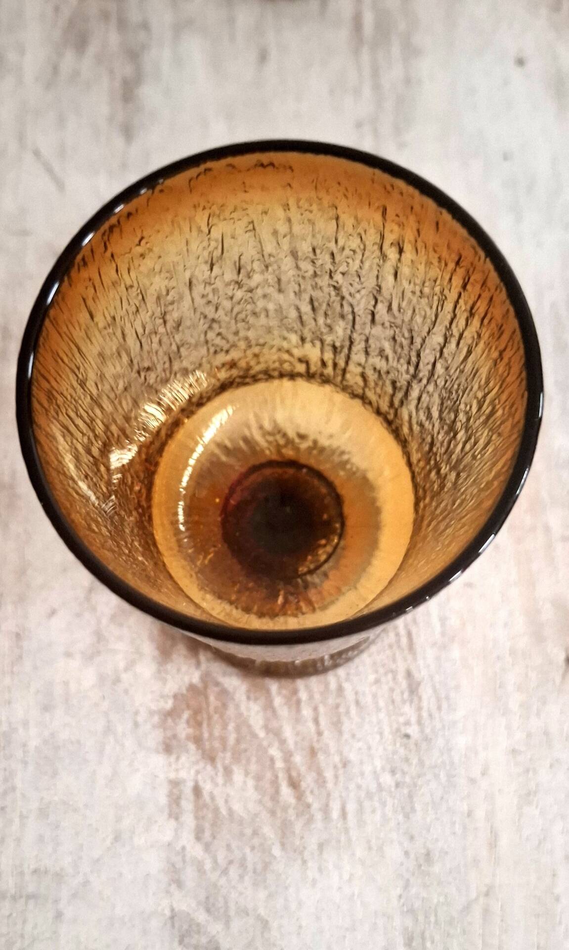 Set of four thick amber glass stemmed glasses.