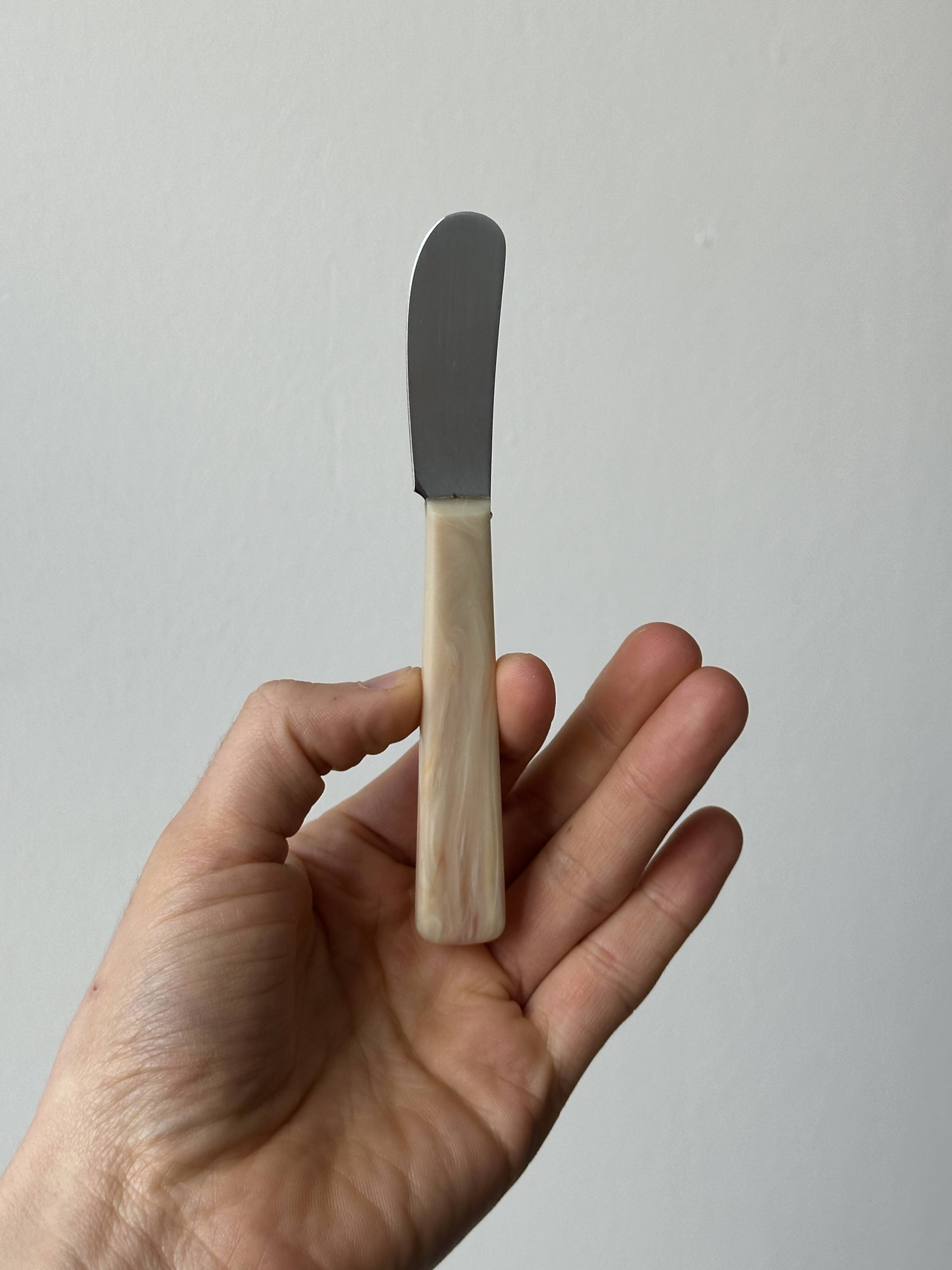 Pink bakelite butter knives.