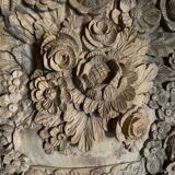 wooden painting with carved floral motif - note a restoration on the left side at the bottom.