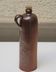 Old enamelled brown sandstone bottle with cork stopper