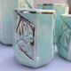 Set of 4 Art Deco celadon green and silver barbotine pots.