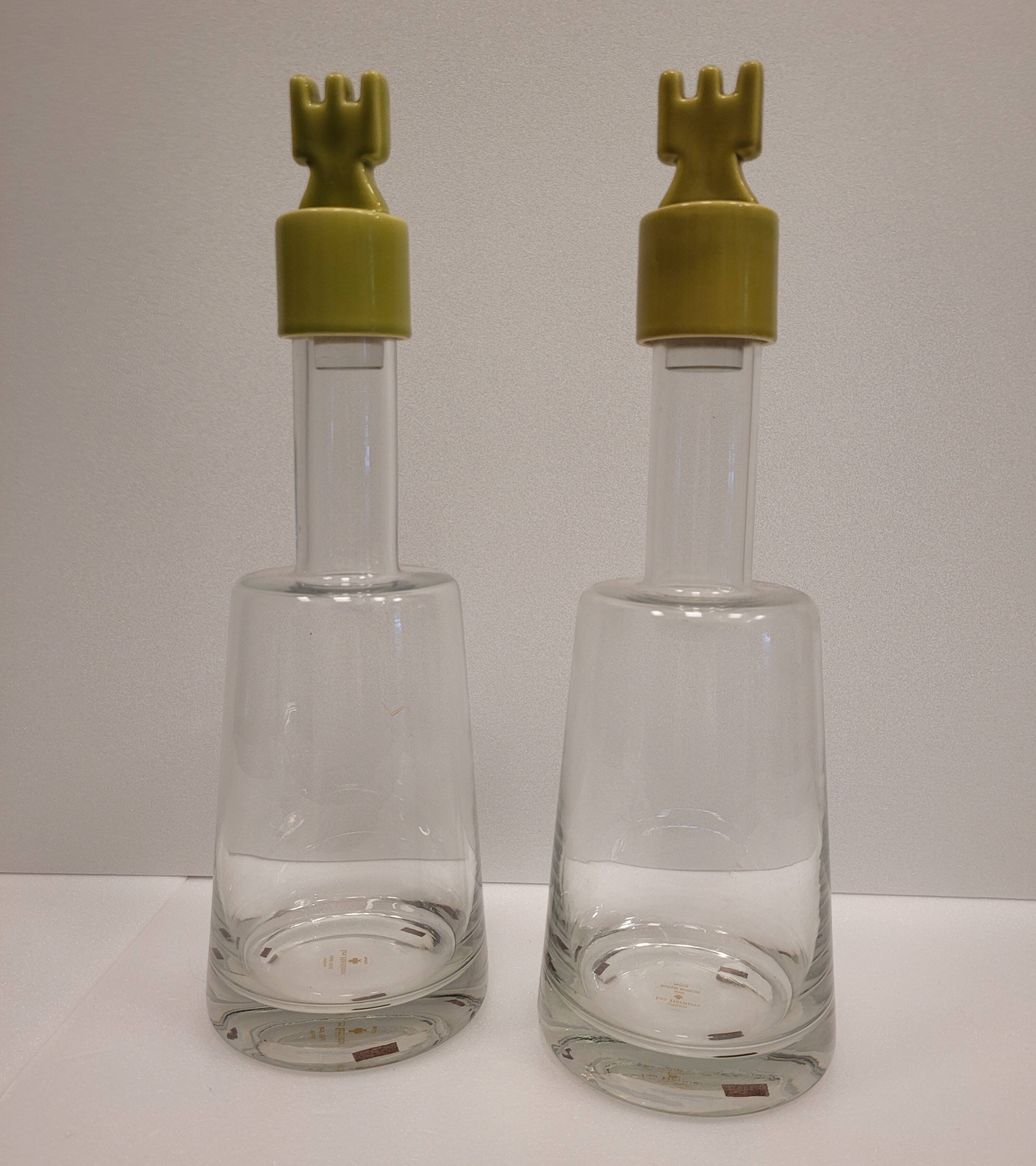pair of decanters, bottles or jars, made in crystal with a ceramic tap enameled in green color
