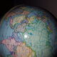 Bright vintage Earth globe brand Vulliermes with metal tripod foot