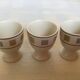 Three egg cups with geometric patterns in beige and brown.