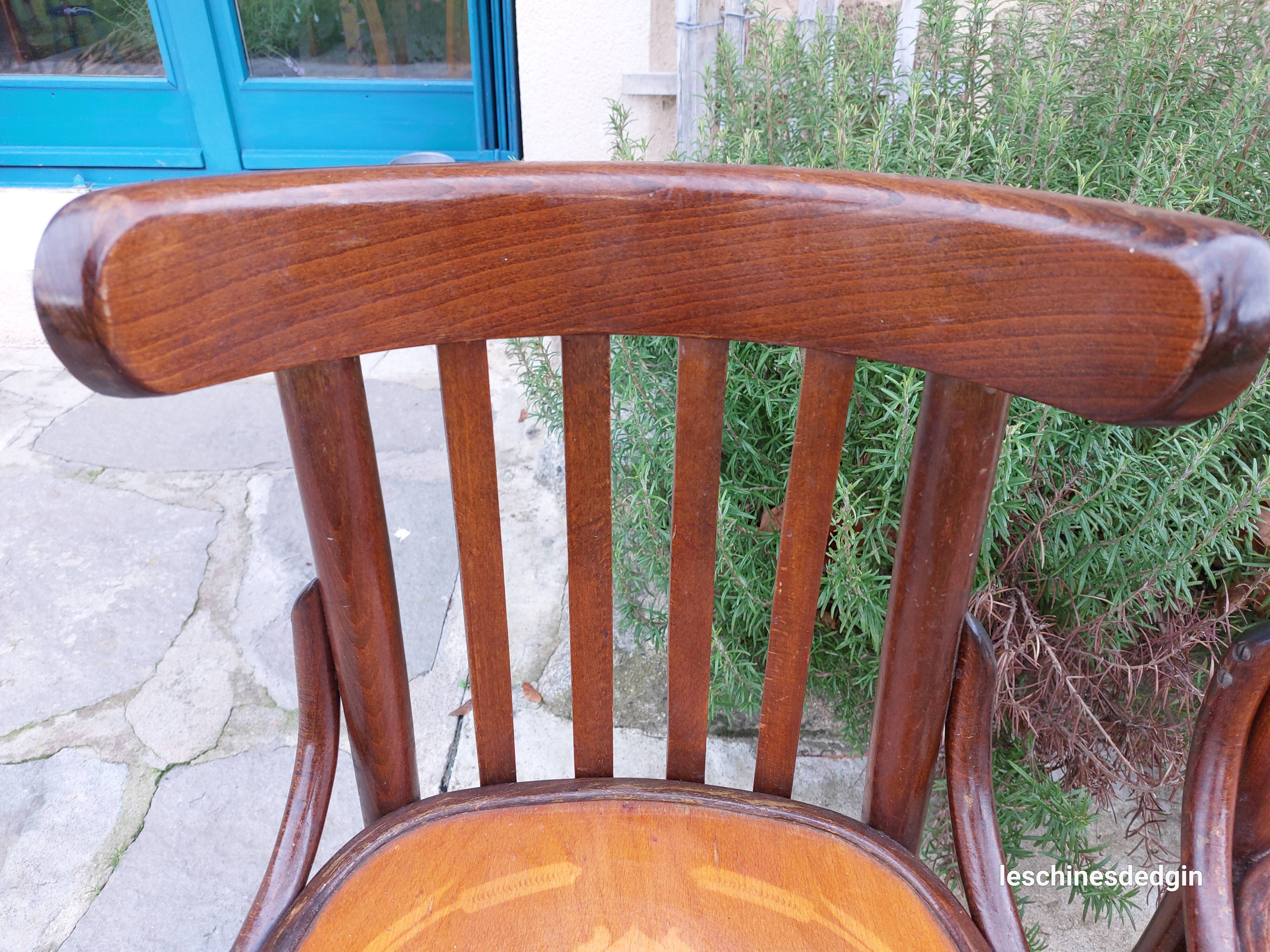 4 bentwood bistro chairs with a pattern on the seat