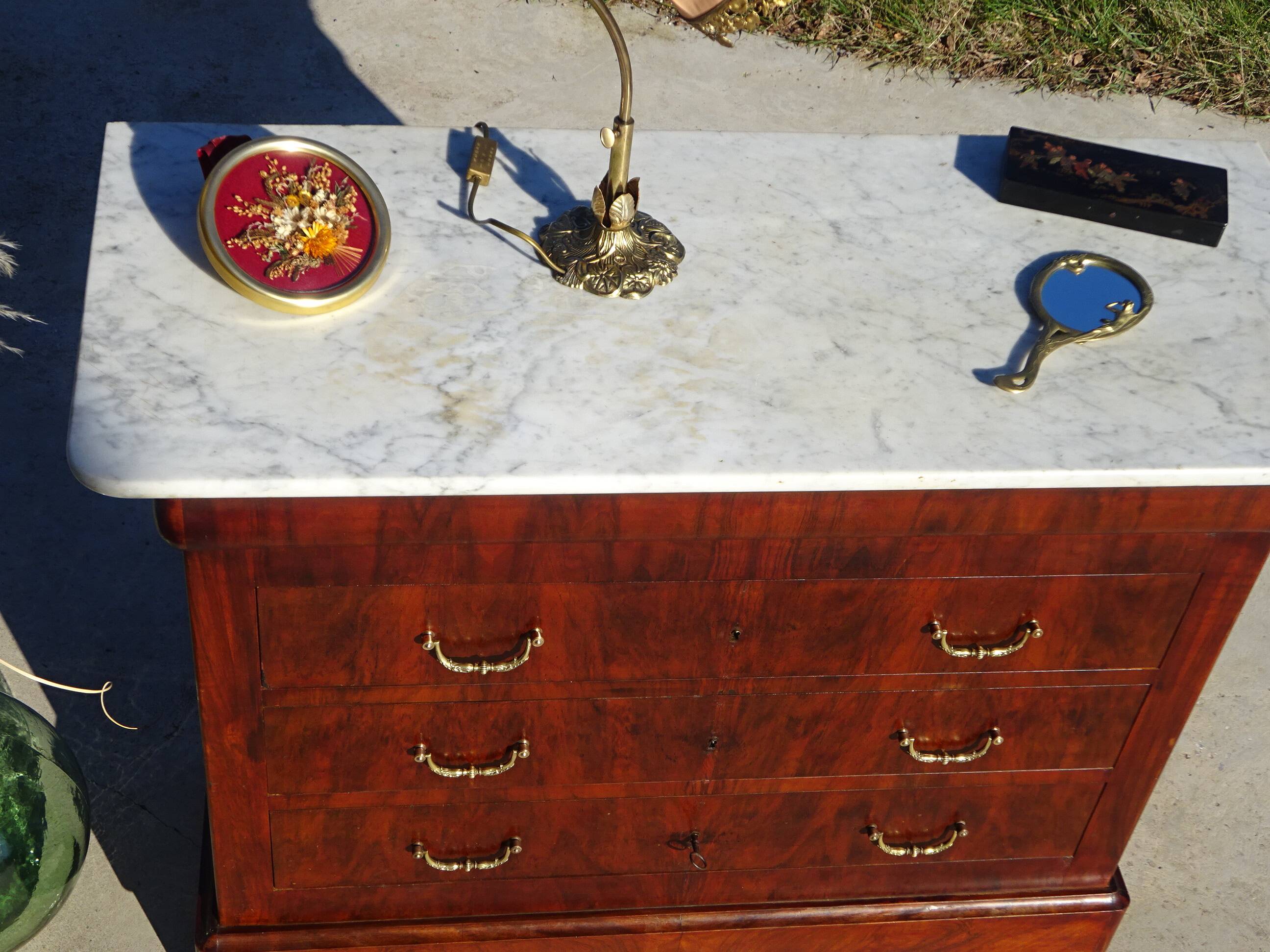 Antique mahogany chest of drawers with white marble.