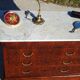 Antique mahogany chest of drawers with white marble.