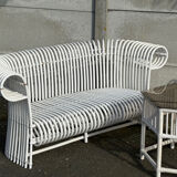 Rattan lounge with two two-seater sofas and a white coffee table.