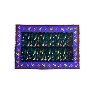 Oltenian floral rug handwoven in wool, purple and black background