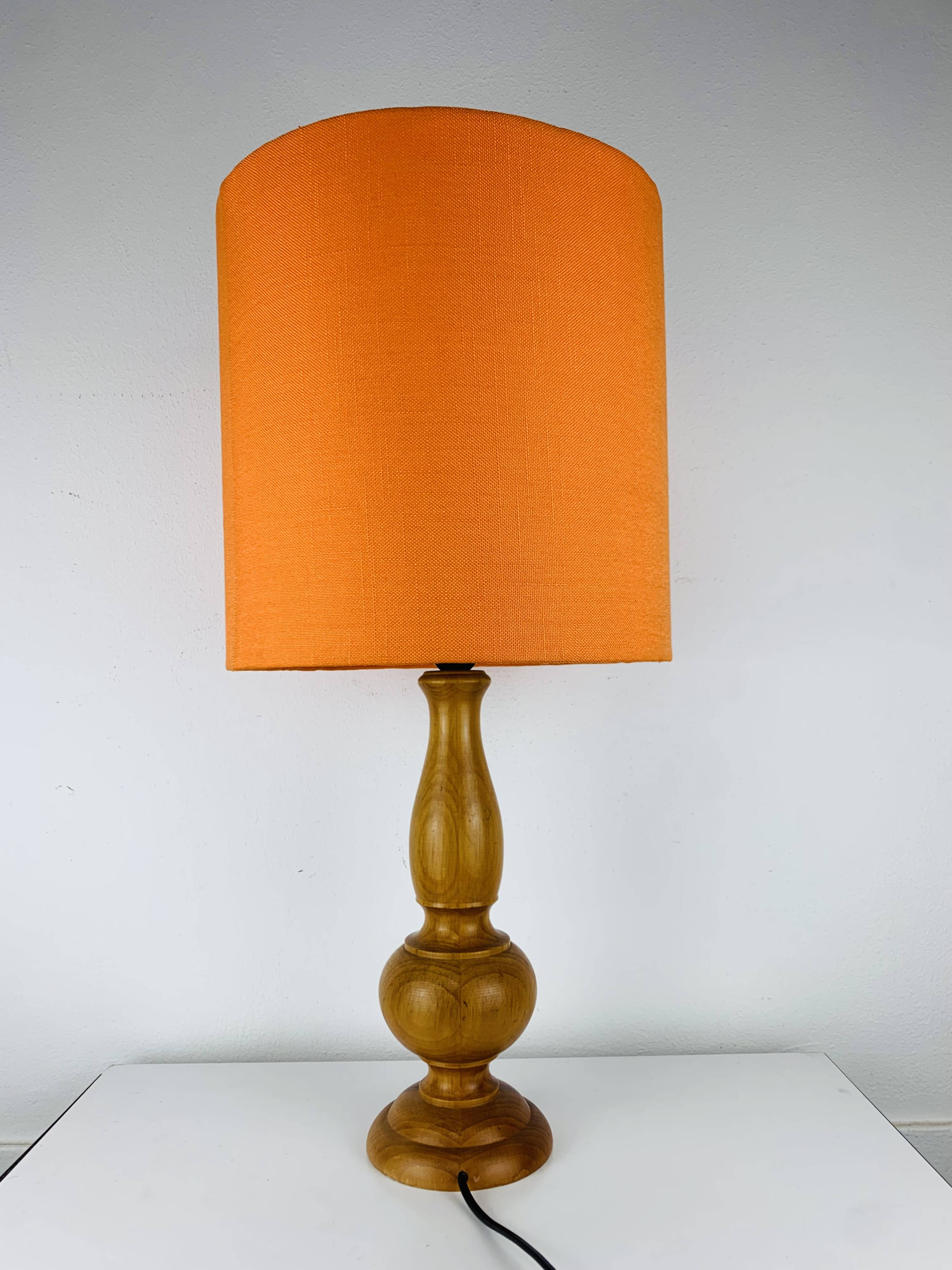 Turned wood lamp with orange shade, 1970s.