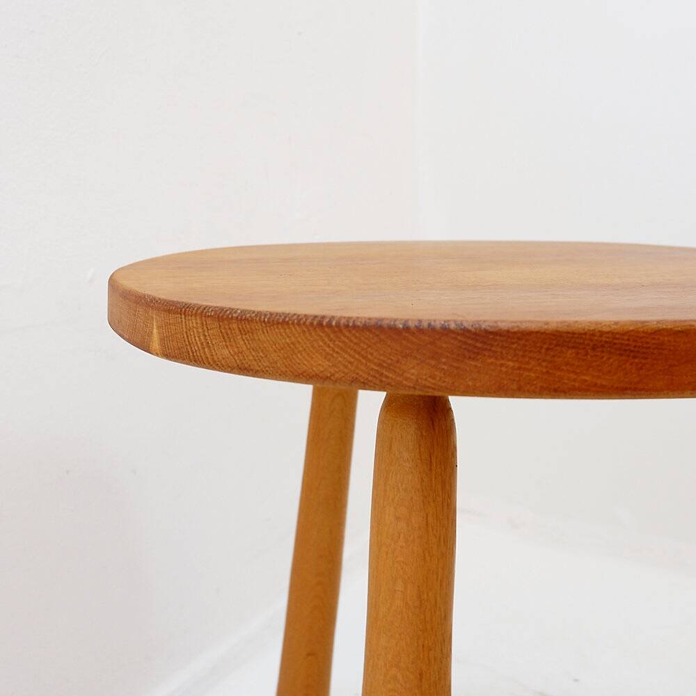 Vintage solid wood side table with rounded legs.