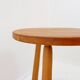 Vintage solid wood side table with rounded legs.