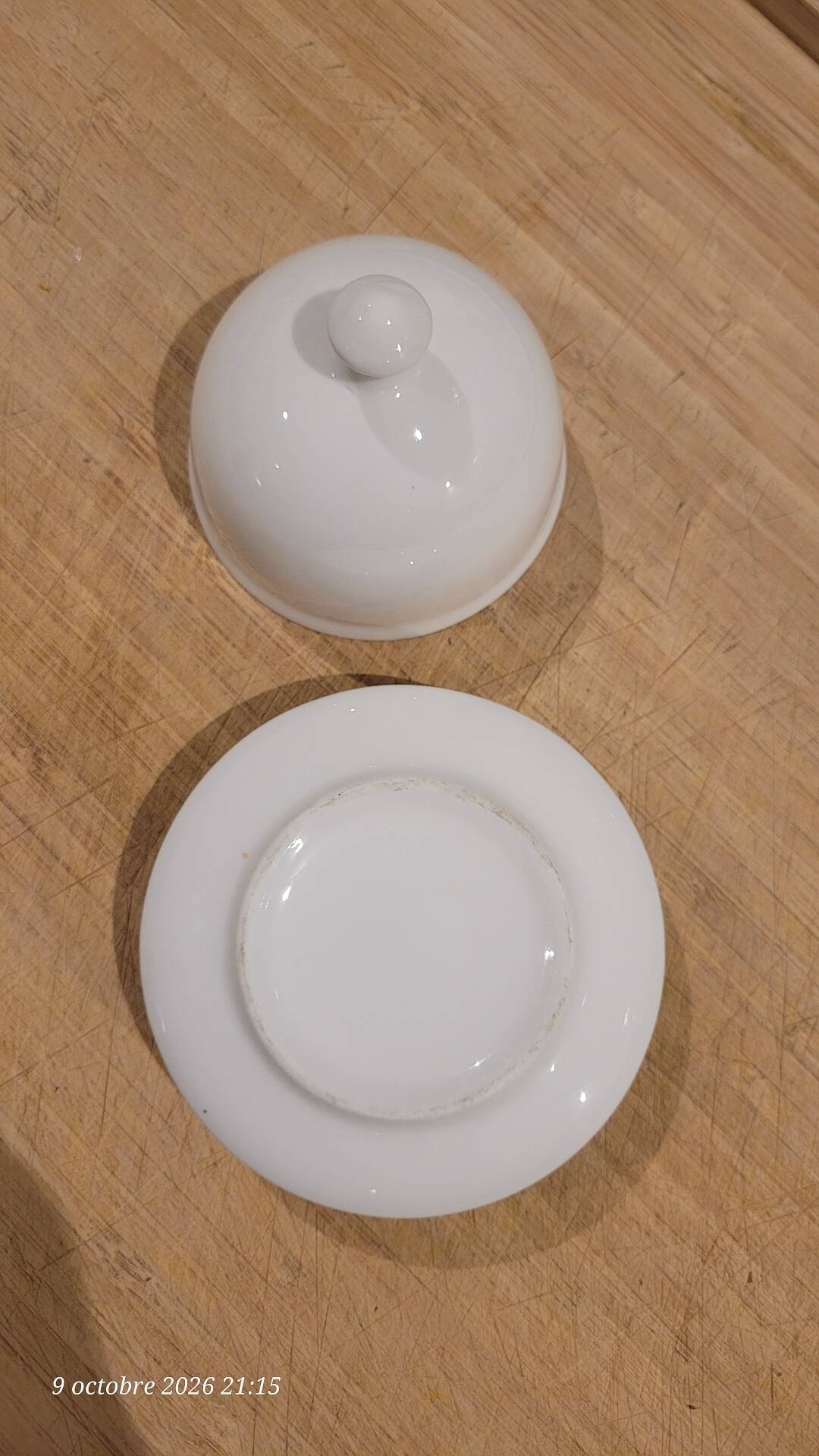 White porcelain butter dish accompanied by its matching bell.