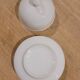 White porcelain butter dish accompanied by its matching bell.