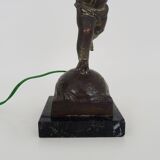 Old table lamp in repel, cherub, angel, cherub, putti with a bird in hand. 1930s