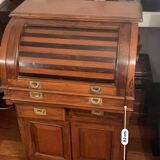 Antique solid wood secretary with a drop-down cylinder compartment.