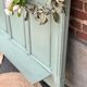 Cloakroom with sage green wall coats