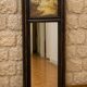 Dark wood trumeau with a mirror and landscape painting.