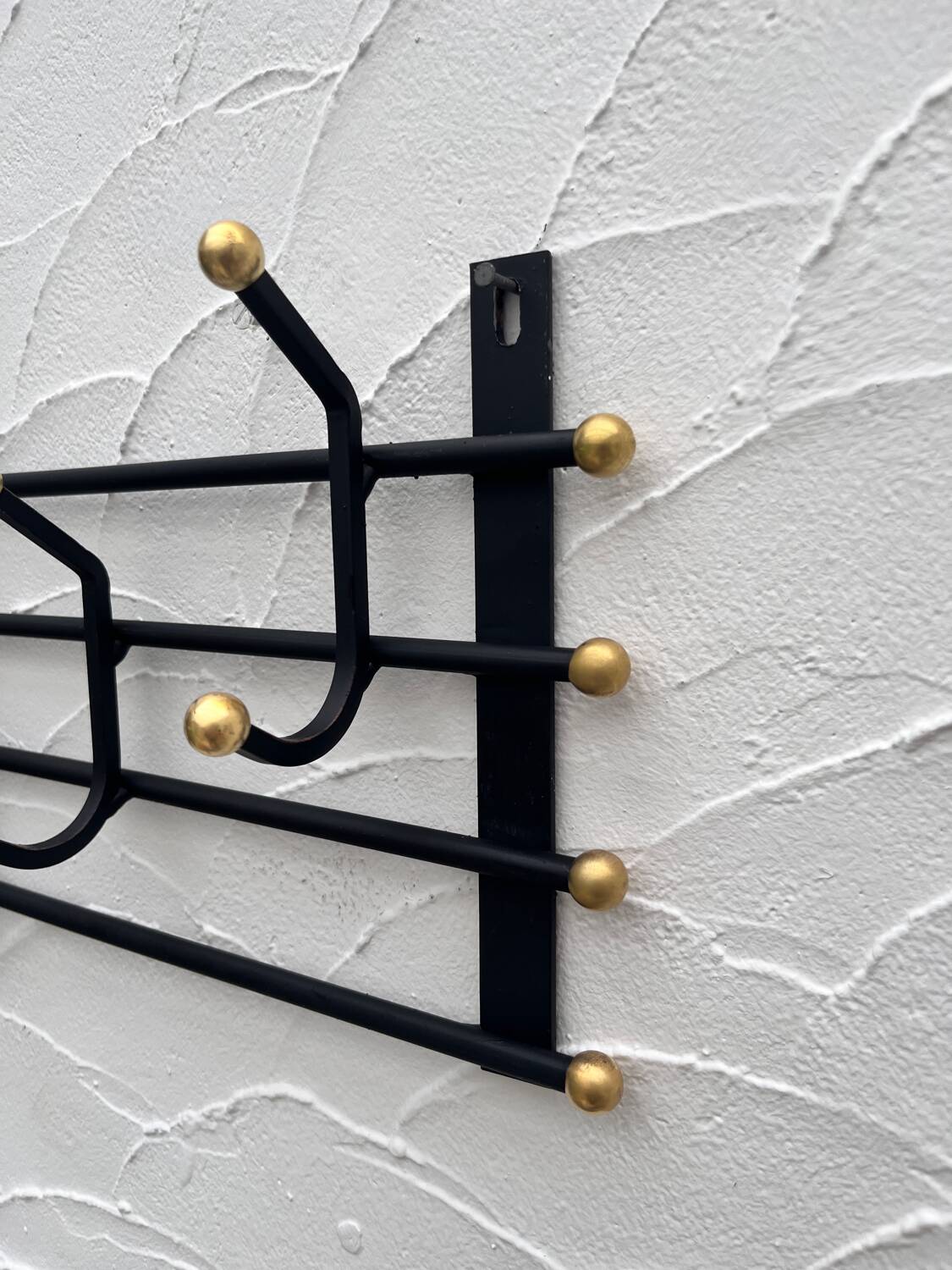Iron and brass coat rack