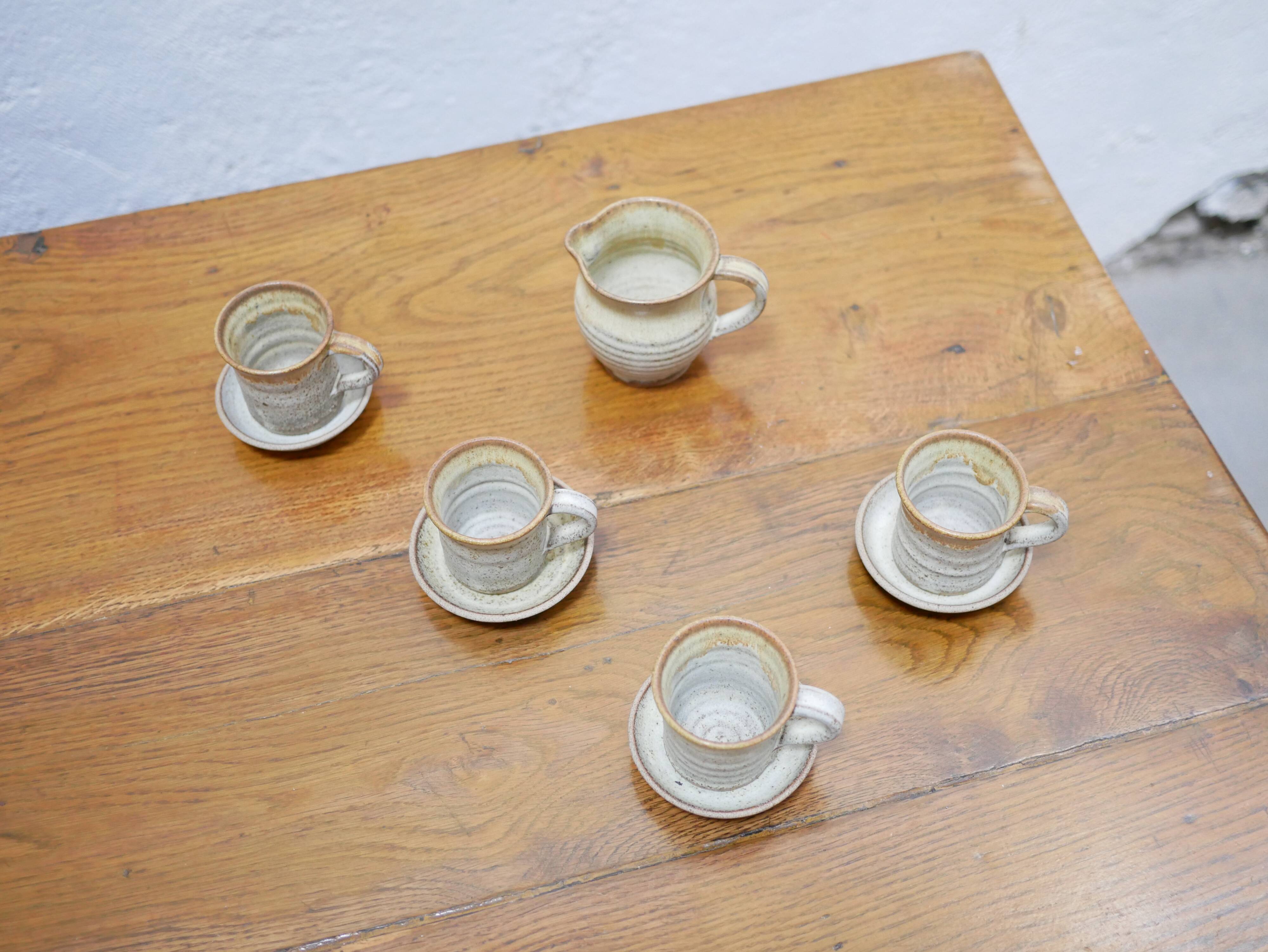 Series of 4 cups and a vintage stoneware milk jug
