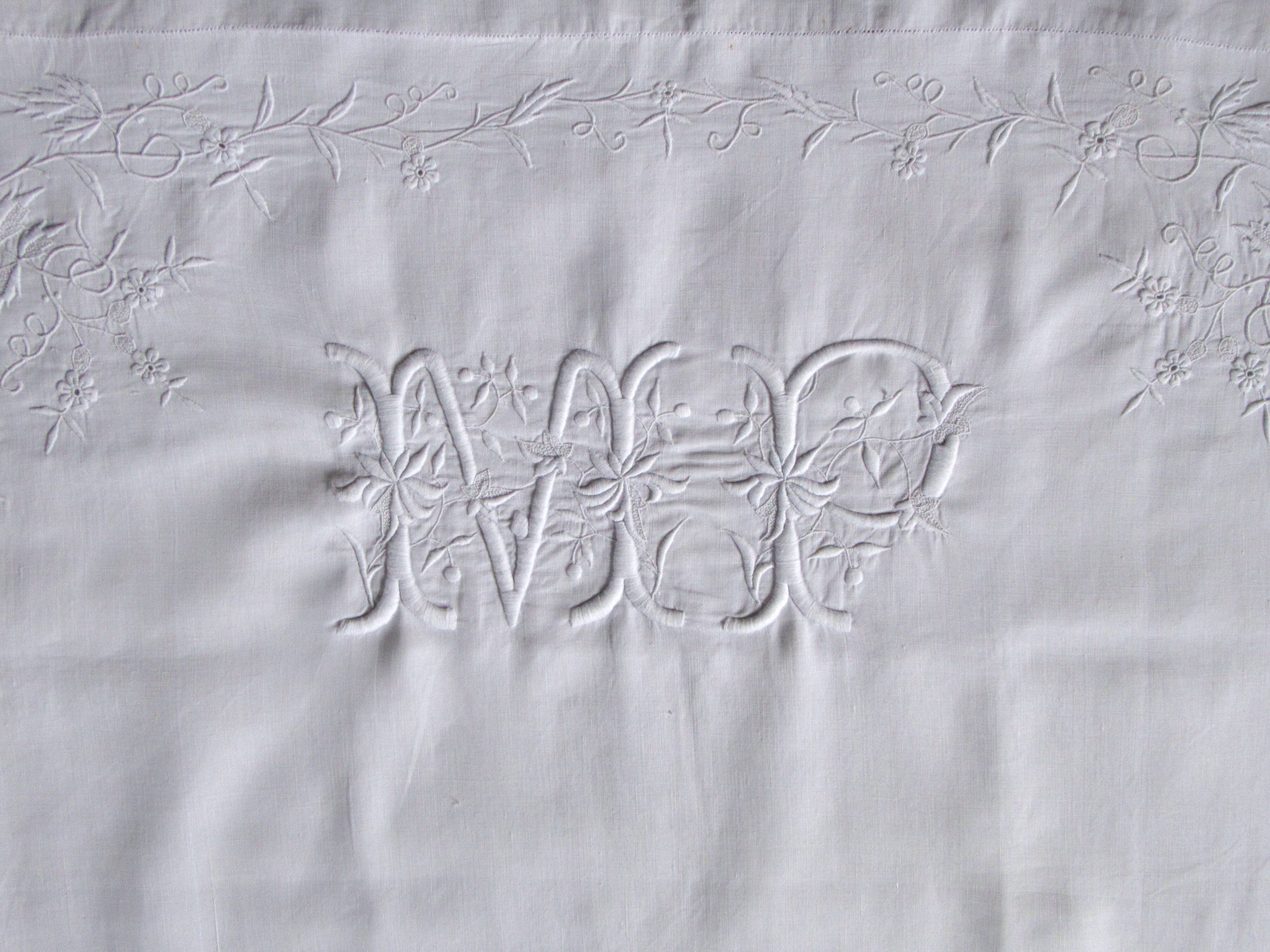 old pillowcase embroidered with fine flowers, marked MP, 19th