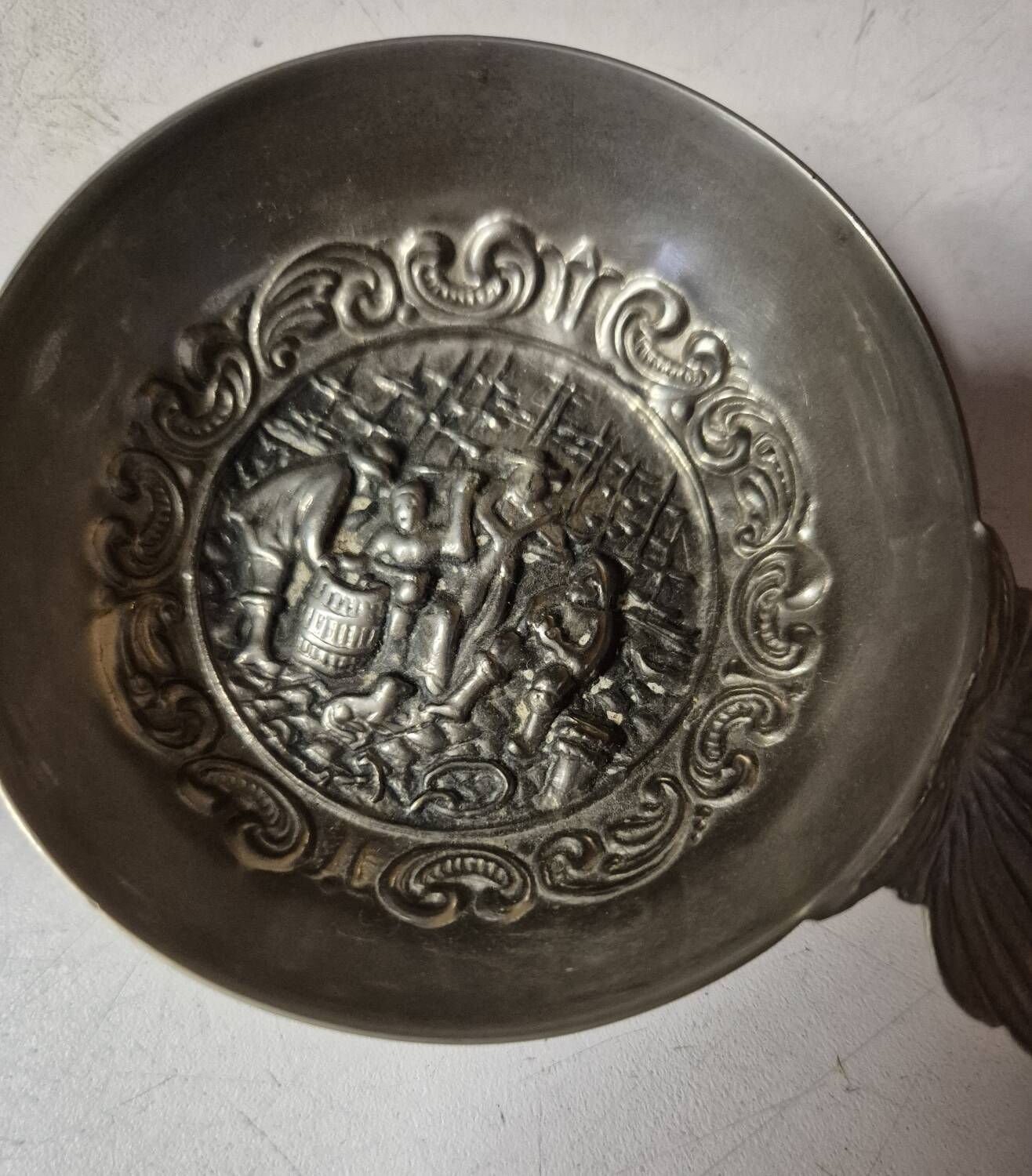 Antique silver-plated metal tastevin with tavern scene decor and shell handle