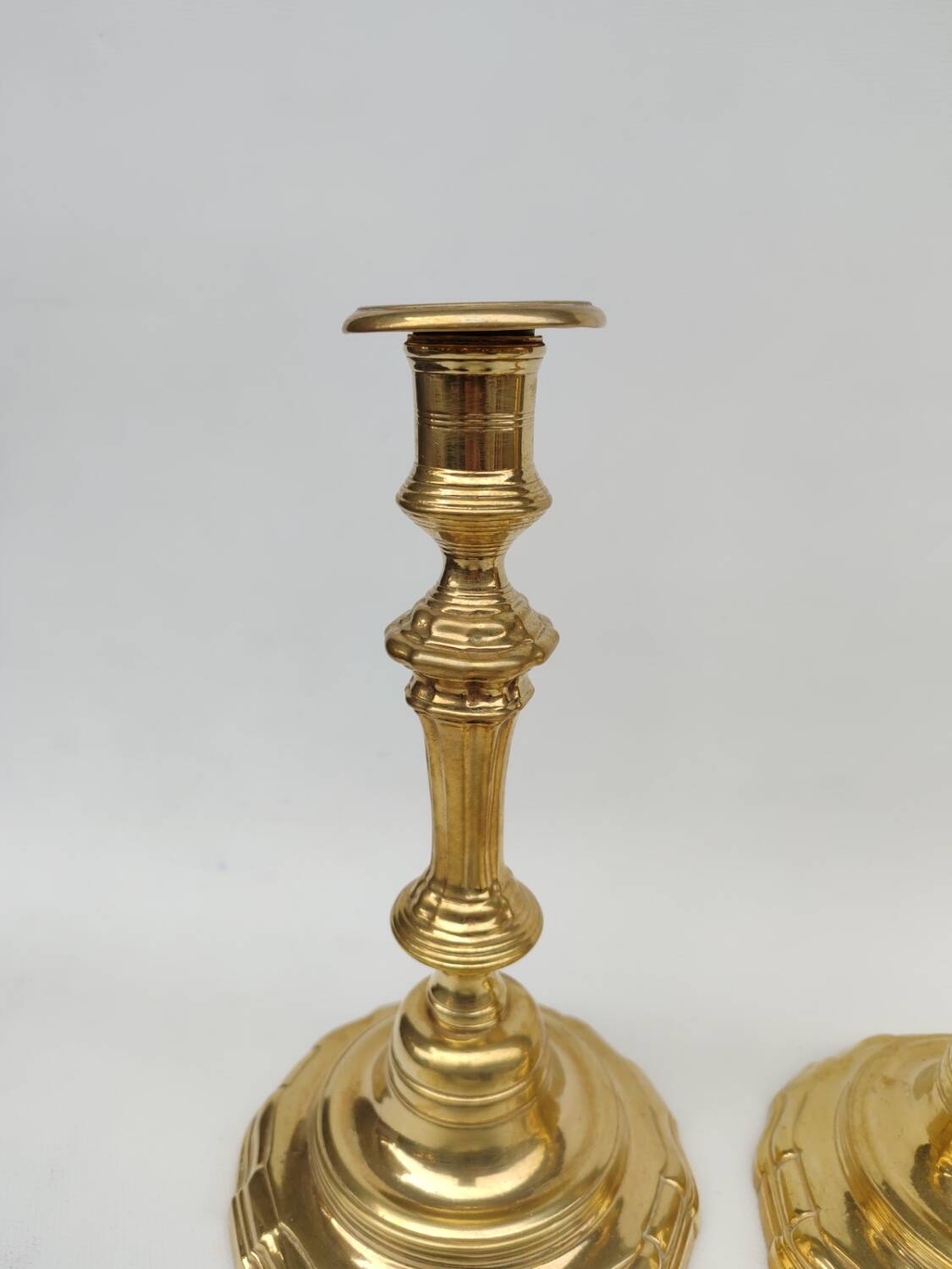 Pair of solid brass candlesticks, early 18th century.