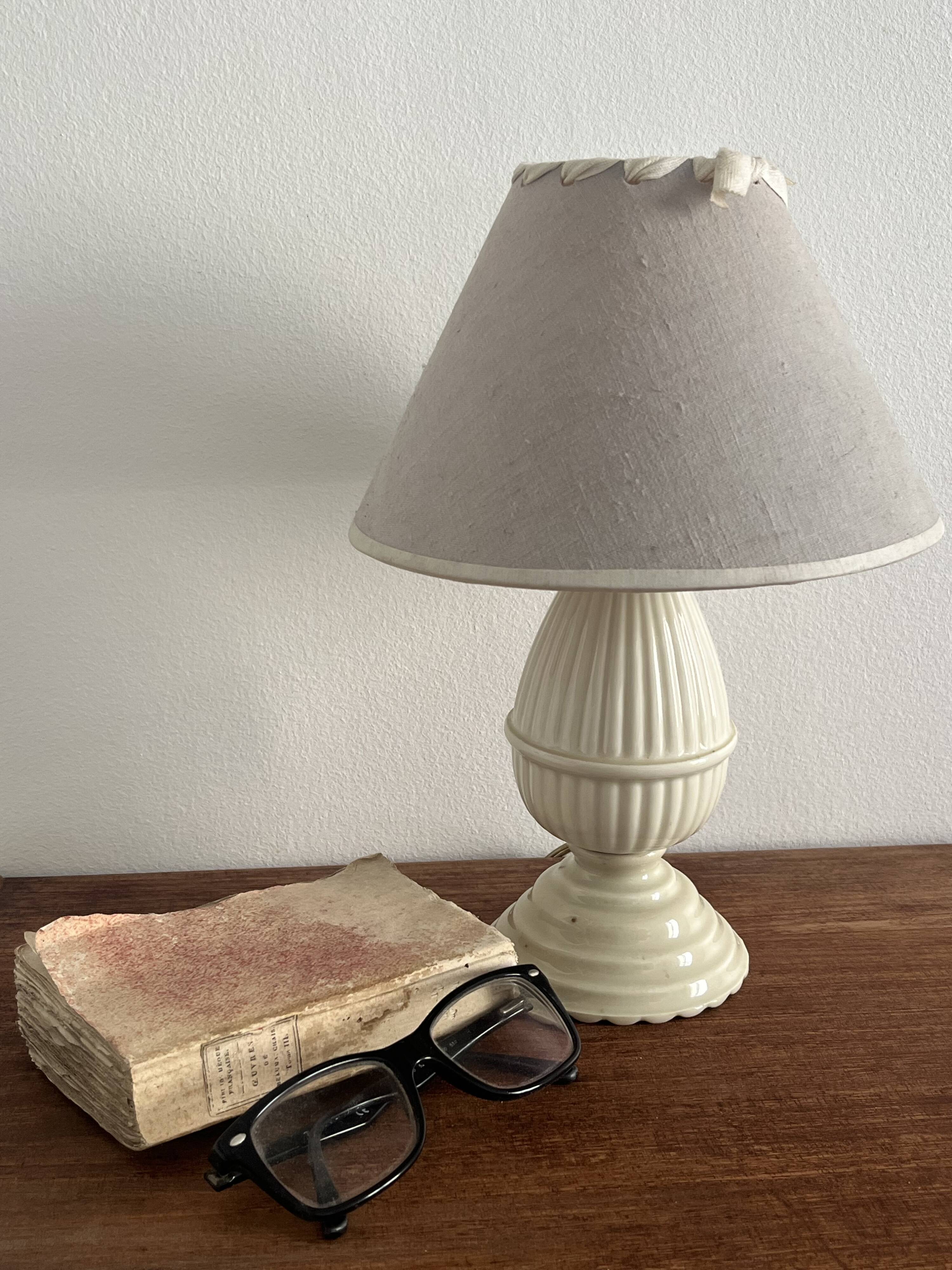 Small bedside lamp in ivory glazed ceramic.
