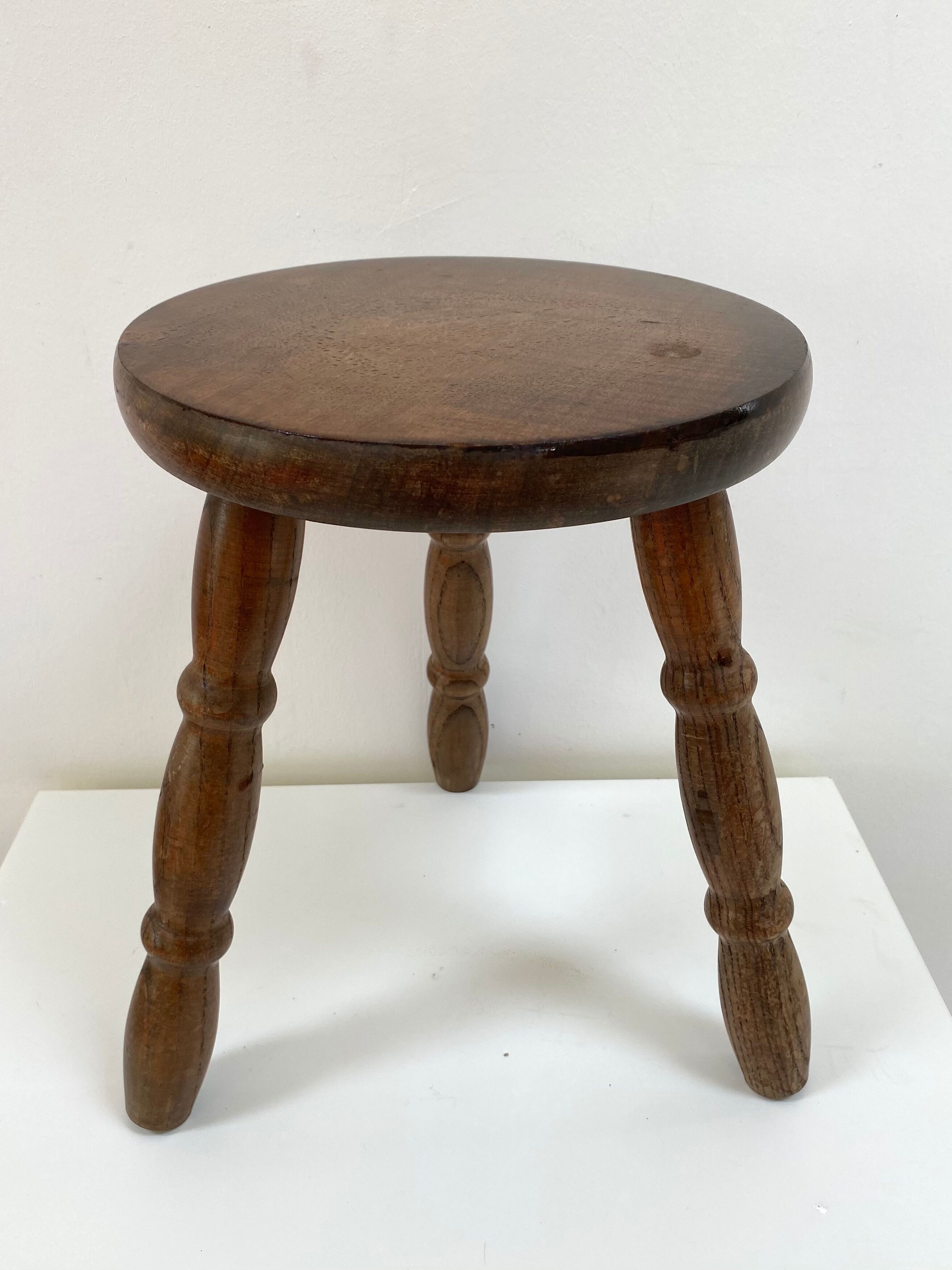 Old wooden tripod stool with ball feet