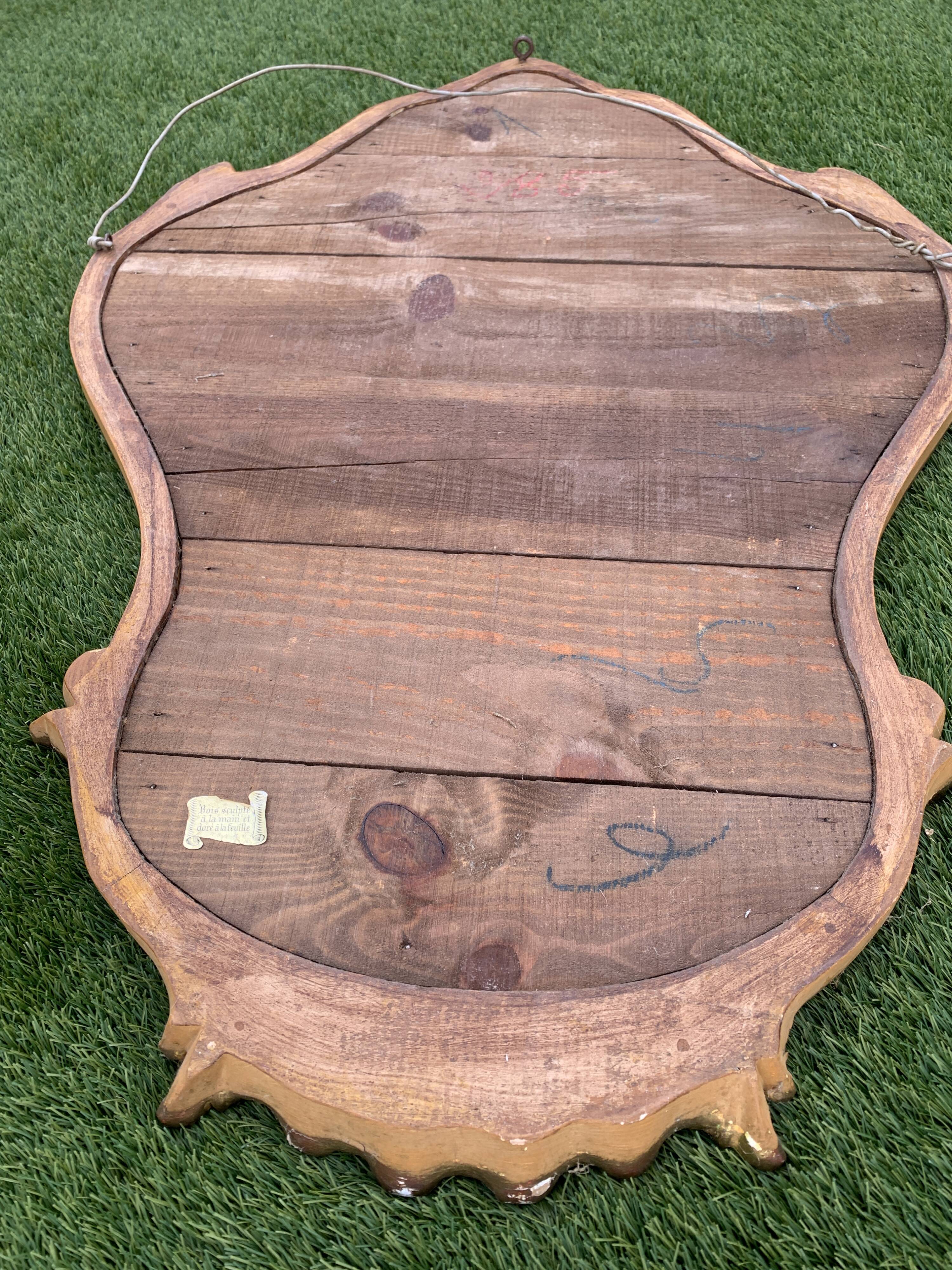 Old mirror in carved wood and gilded leaf, Louis XV rocaille style, twentieth century 59x87cm