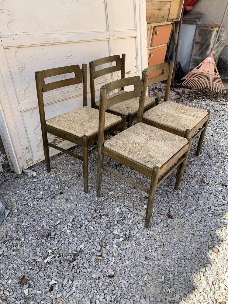 Set of 4 brown wooden dining chairs with straw seats, 1970s.