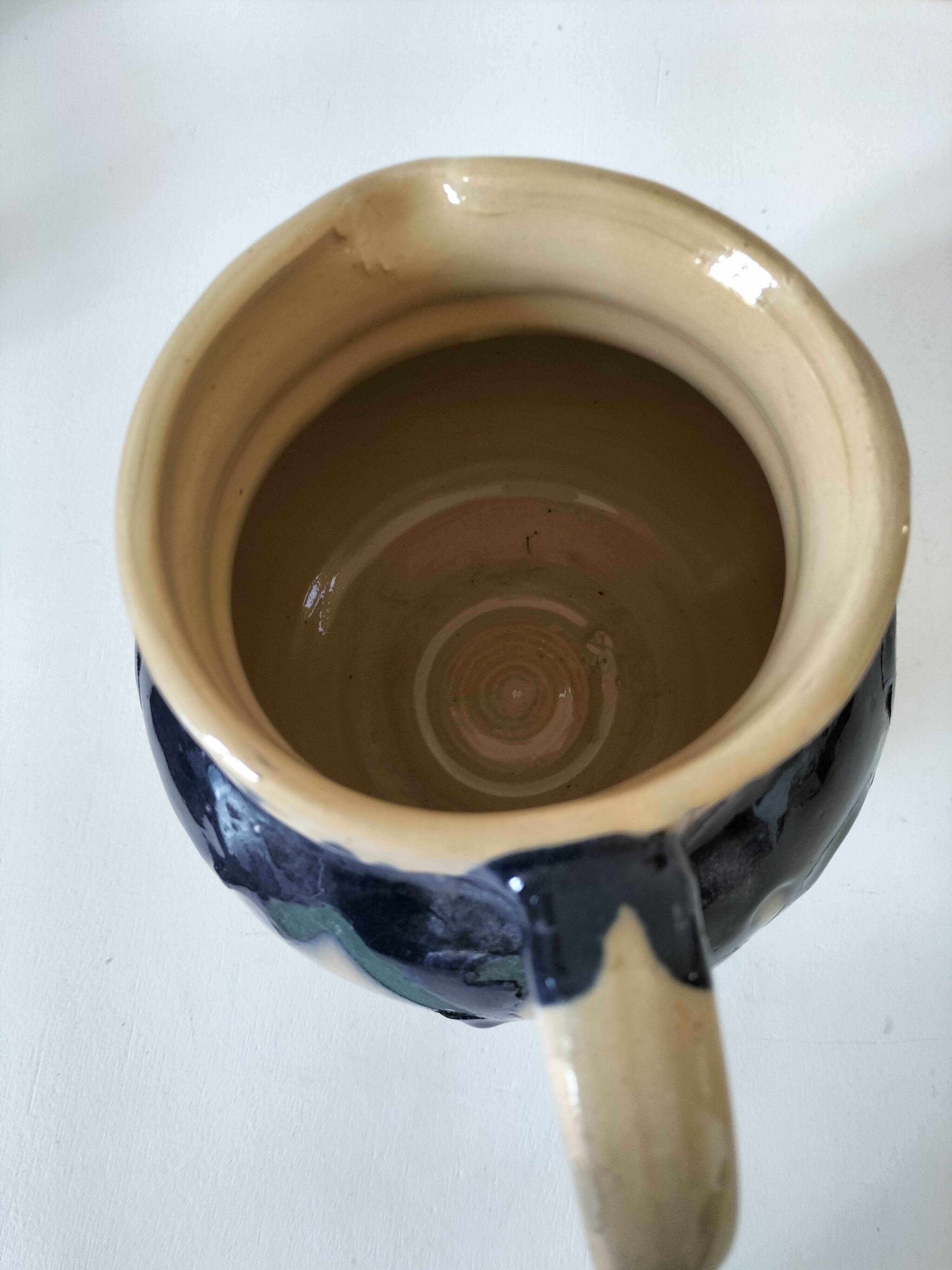 handcrafted ceramic jug with navy blue drip glaze.