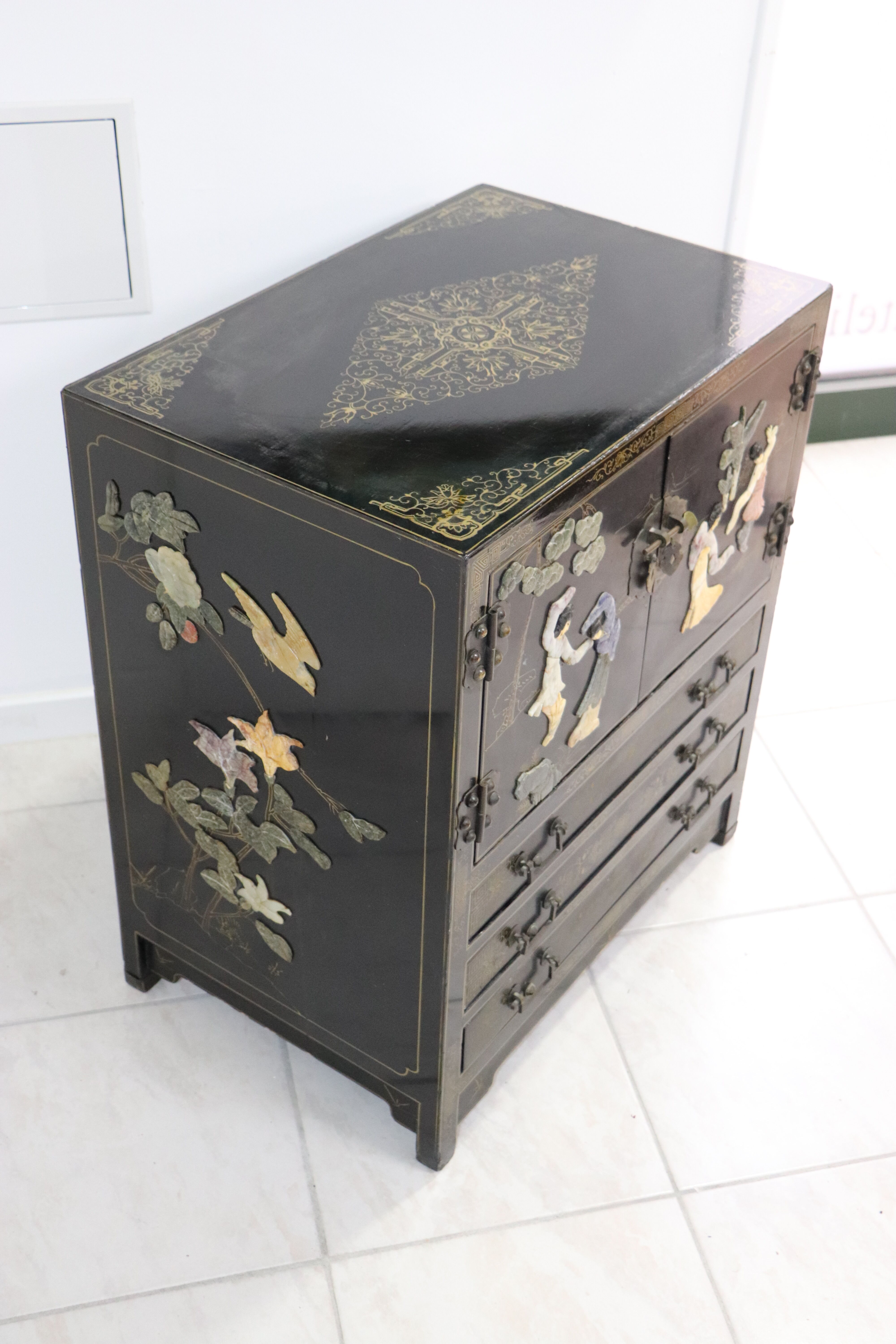 Black lacquered Chinese buffet with stone and ivory figures
