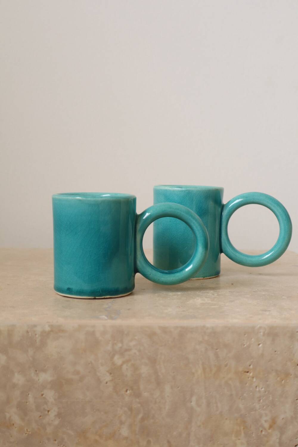 Pair of handmade turquoise ceramic coffee cups with large handles
