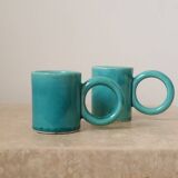 Pair of handmade turquoise ceramic coffee cups with large handles