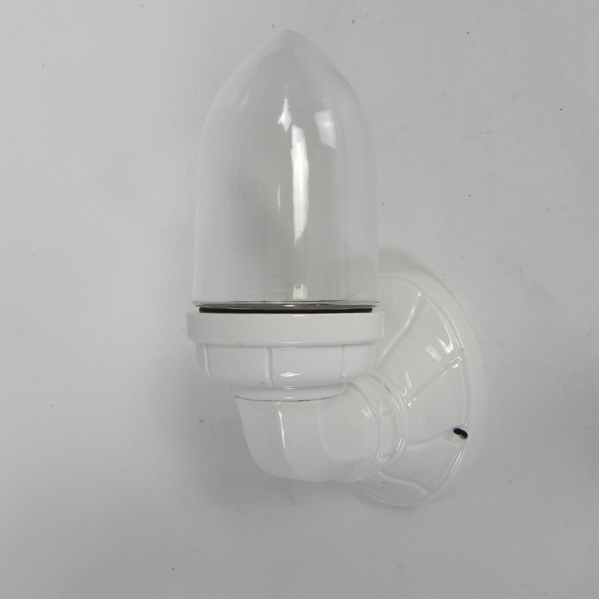 Wall lamp in porcelain with a transparent glass shade, 1930s.