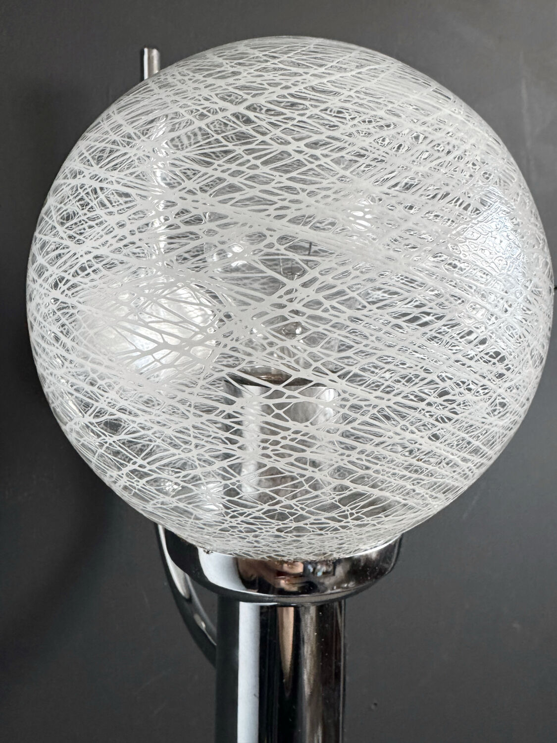 Chrome wall light with blown glass from the 1970s.