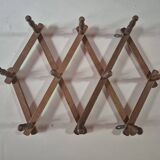 vintage wooden coat rack folds out like an accordion